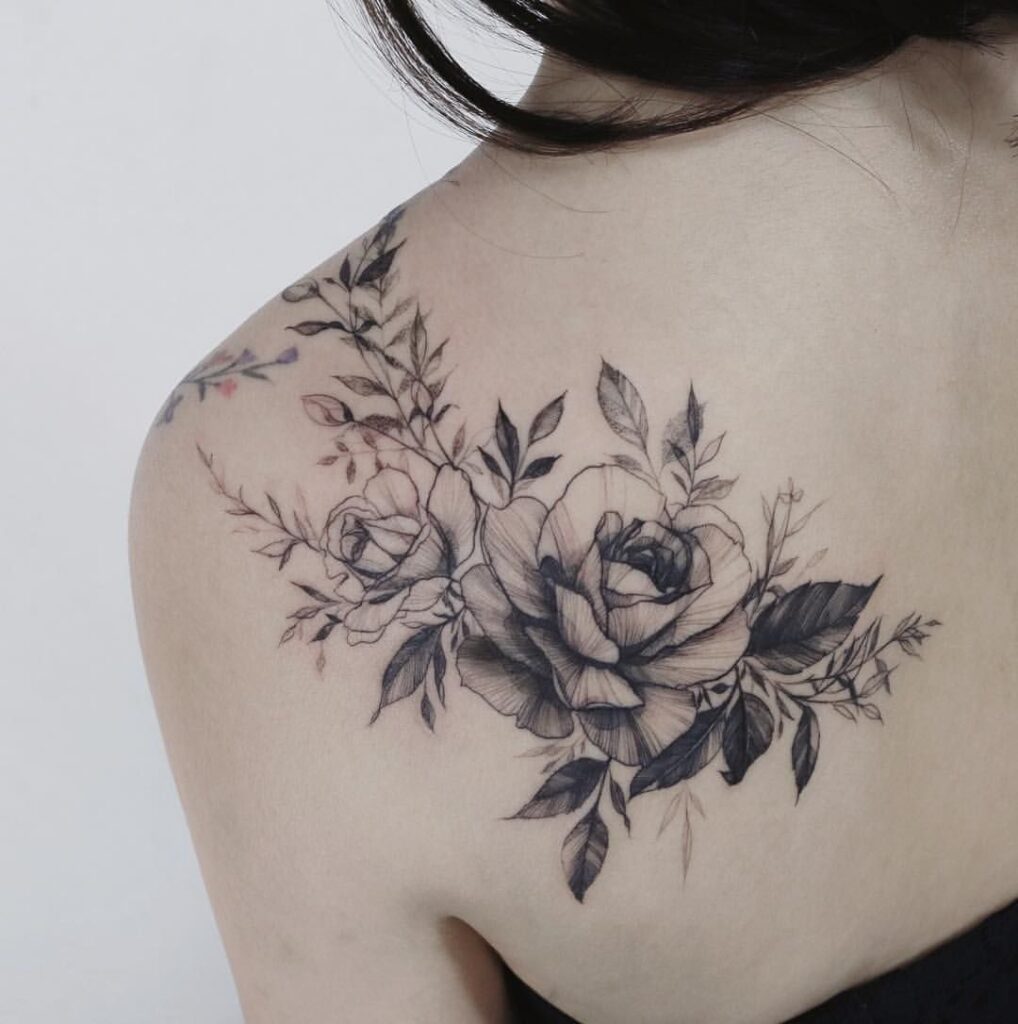 Tattoo of two roses on the shoulder blade for women