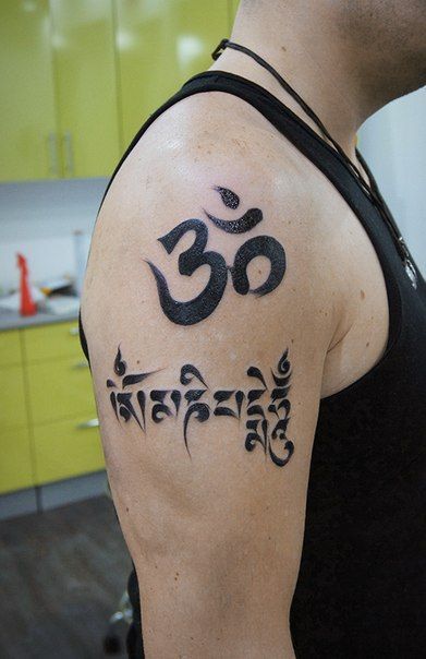 Tattoo of a symbol on the shoulder for men