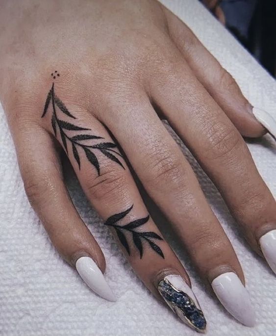 Large leaf tattoo on the finger for women