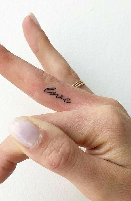 Tattoo with an inscription on the finger for women