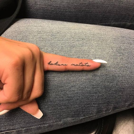 Tattoo with an inscription on the finger for women