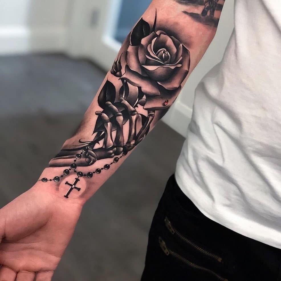 Large rose and cross tattoo on the arm for men