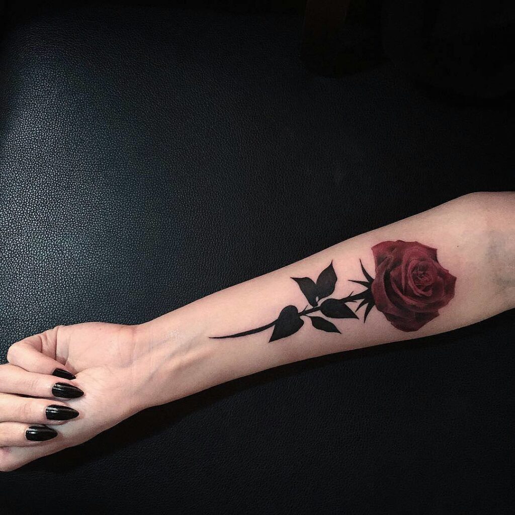 Colorful rose tattoo on the arm for women