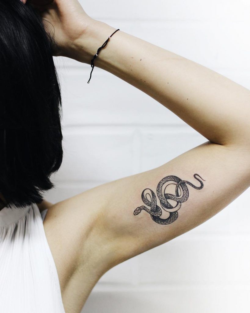 Snake tattoo on the arm for women