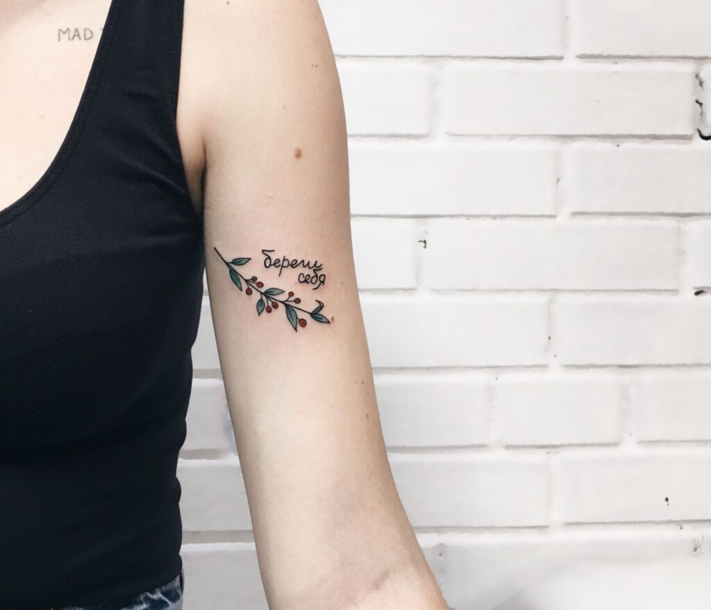 Tattoo with an inscription on the arm for women