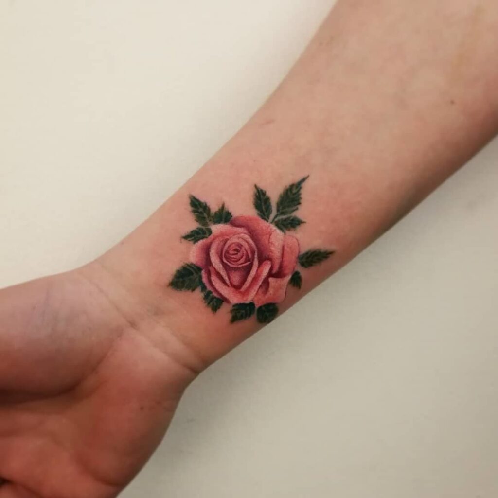 Colorful rose tattoo on the arm for women