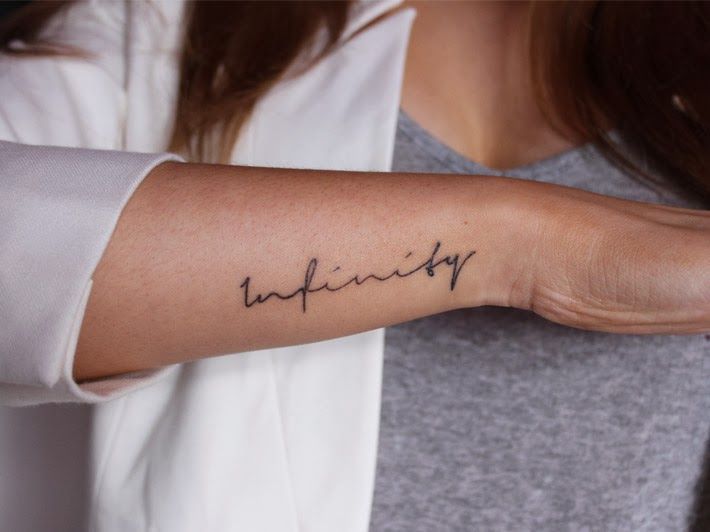 Tattoo with an inscription on the arm for women