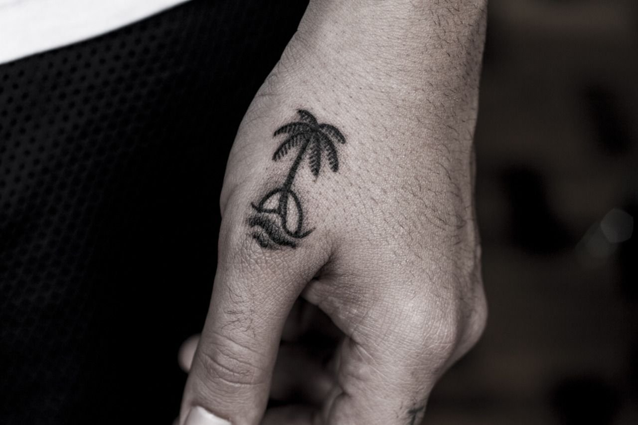 Palm tree tattoo on the hand for men