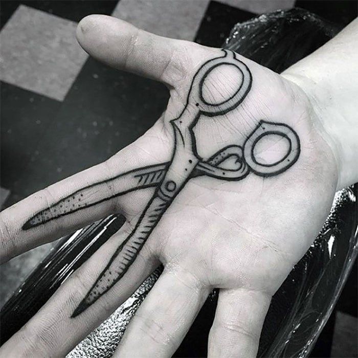 Large scissors tattoo on the palm of the hand for men