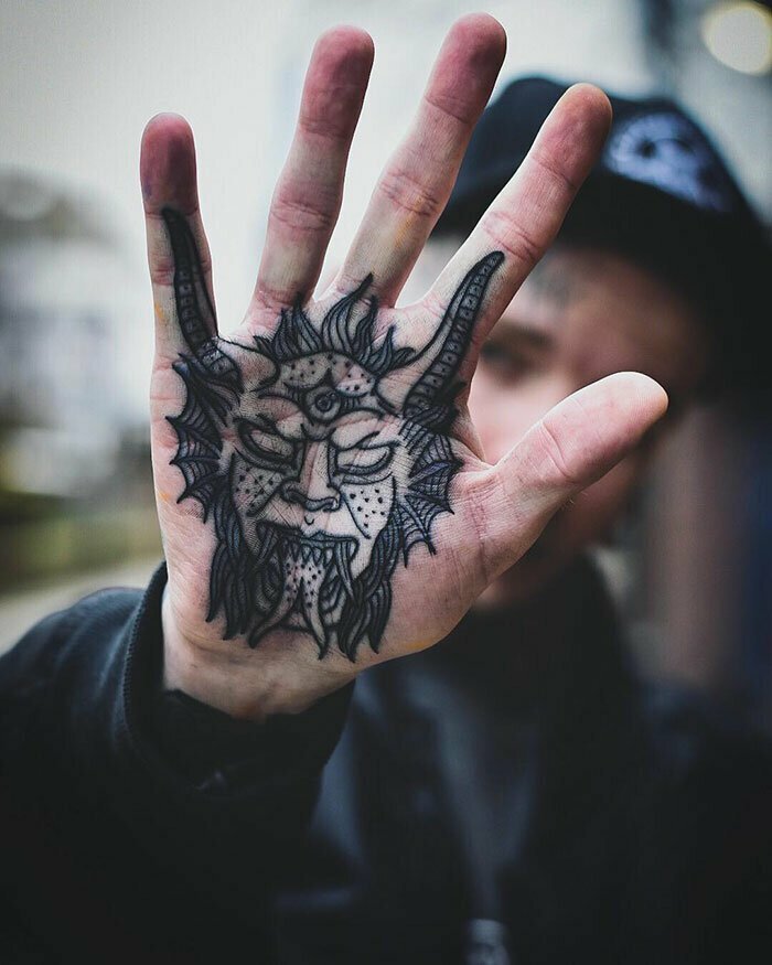 Devil tattoo on the palm of the hand for men