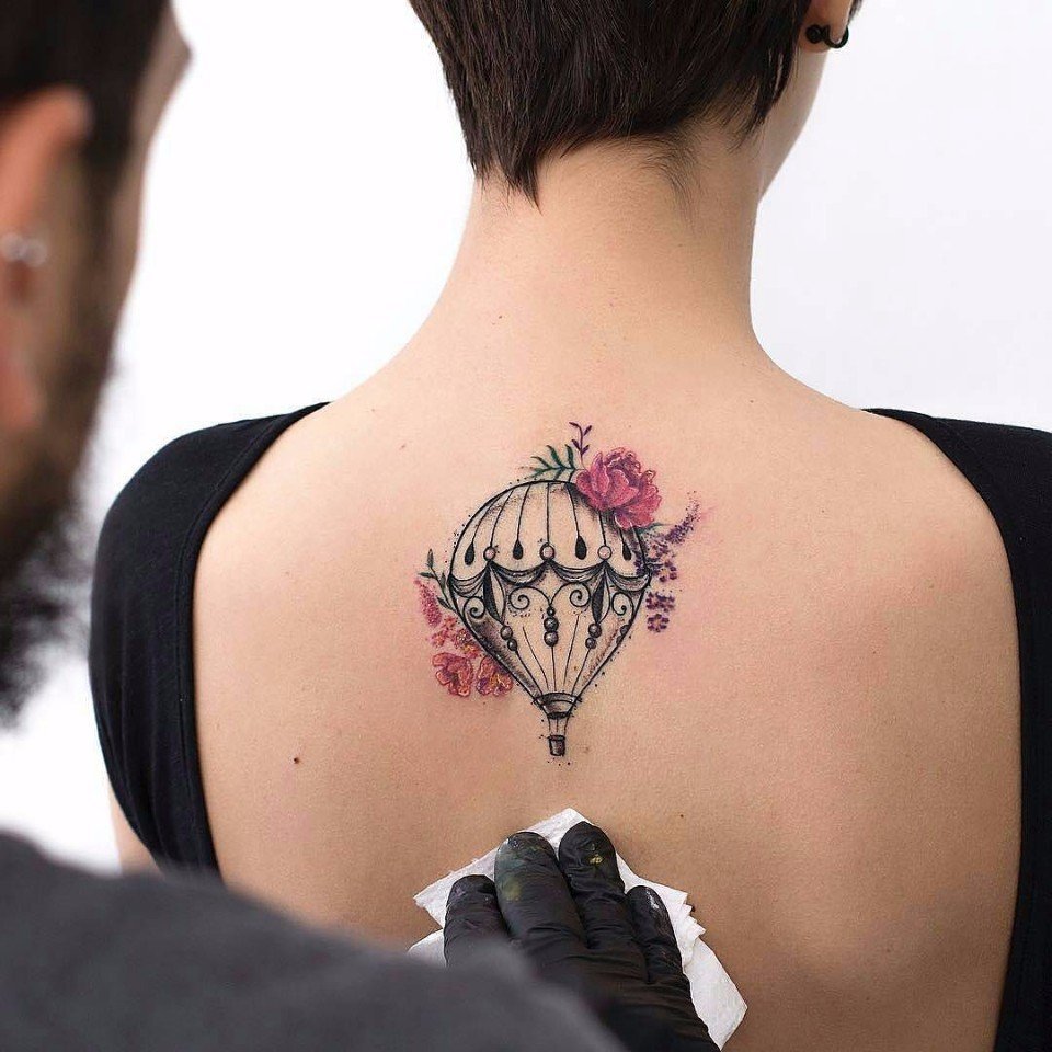 Colored balloon tattoo on the back for women