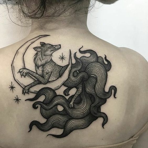 Large fox and month tattoo on the back for women