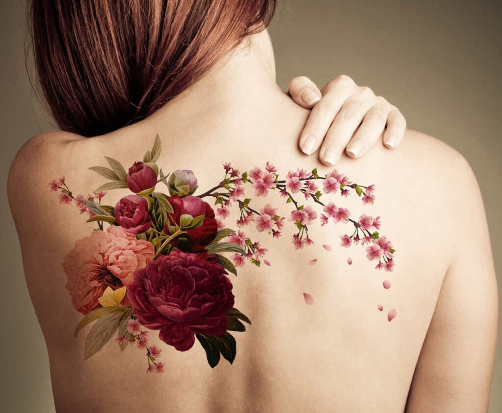 Color tattoo of peonies on the back for women