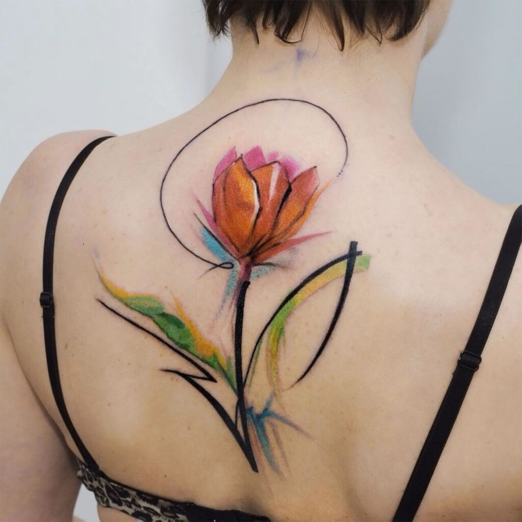 Color tattoo of a tulip on the back for women