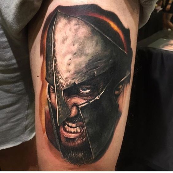 Colored tattoo of a spartan on the thigh for men