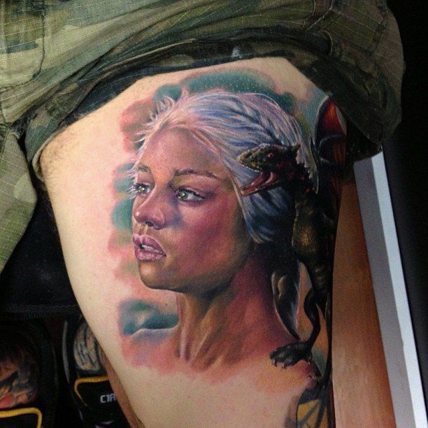 Colored tattoo of a girl on the hip for men