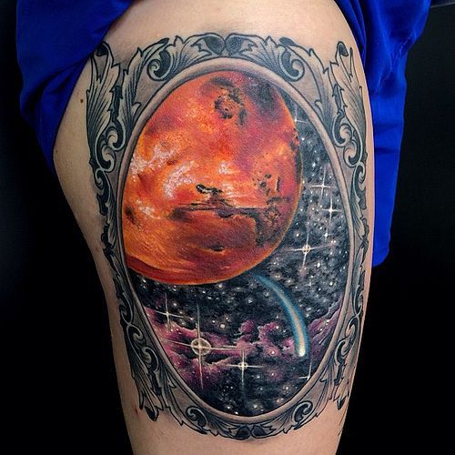 Space tattoo on the thigh for men