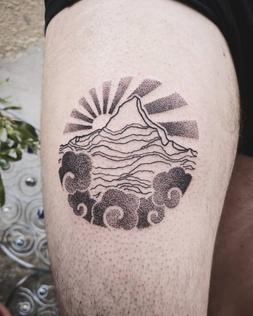 Tattoo of the sun and mountains on the hip for men