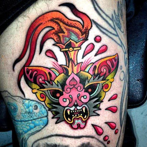 Color tattoo on the thigh for men