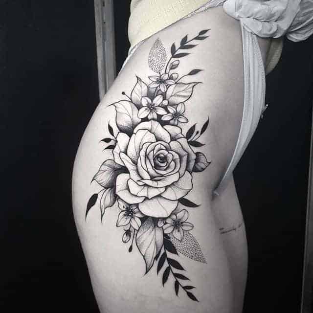 Large rose tattoo on the thigh for women