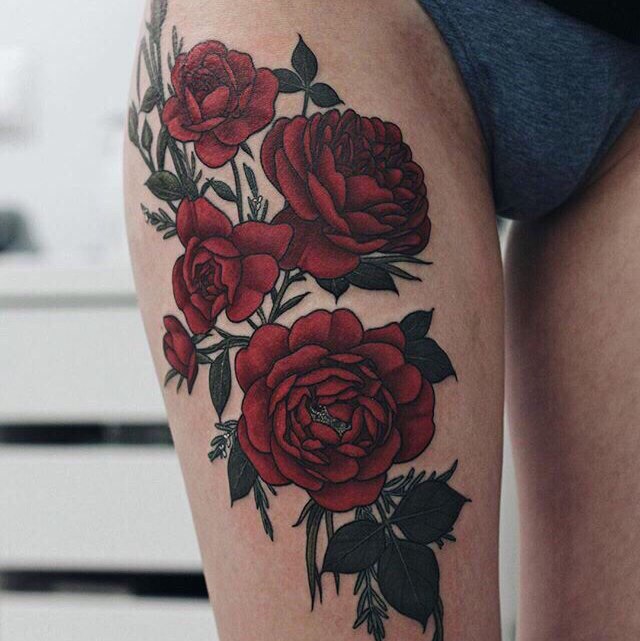 Colorful rose tattoo on the hip for women