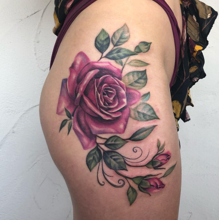 Colorful rose tattoo on the hip for women