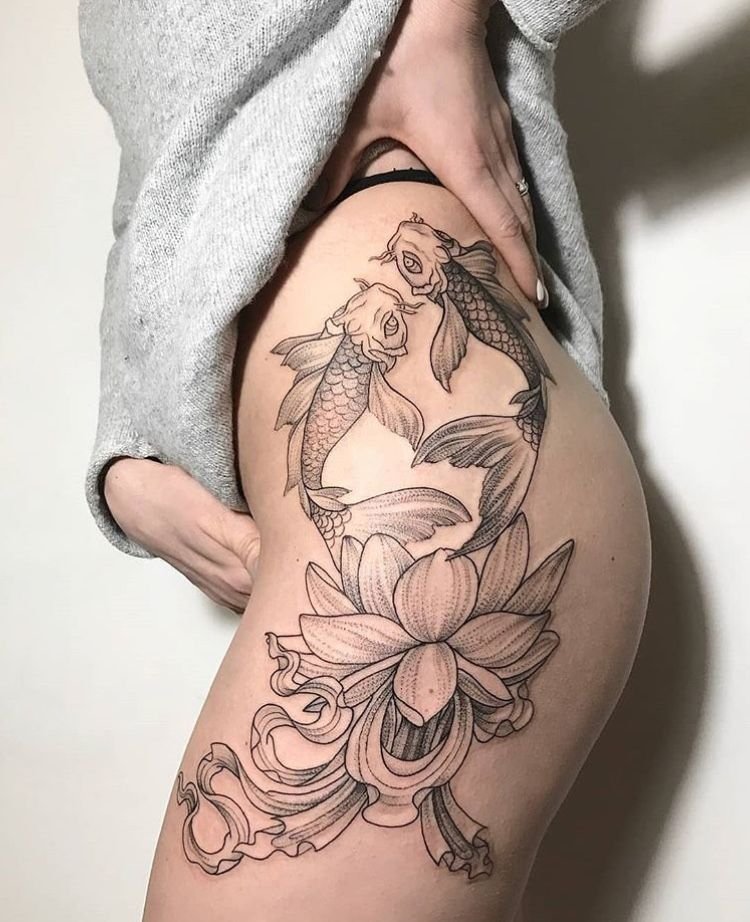 Tattoo of koi fish and flowers on the thigh for women