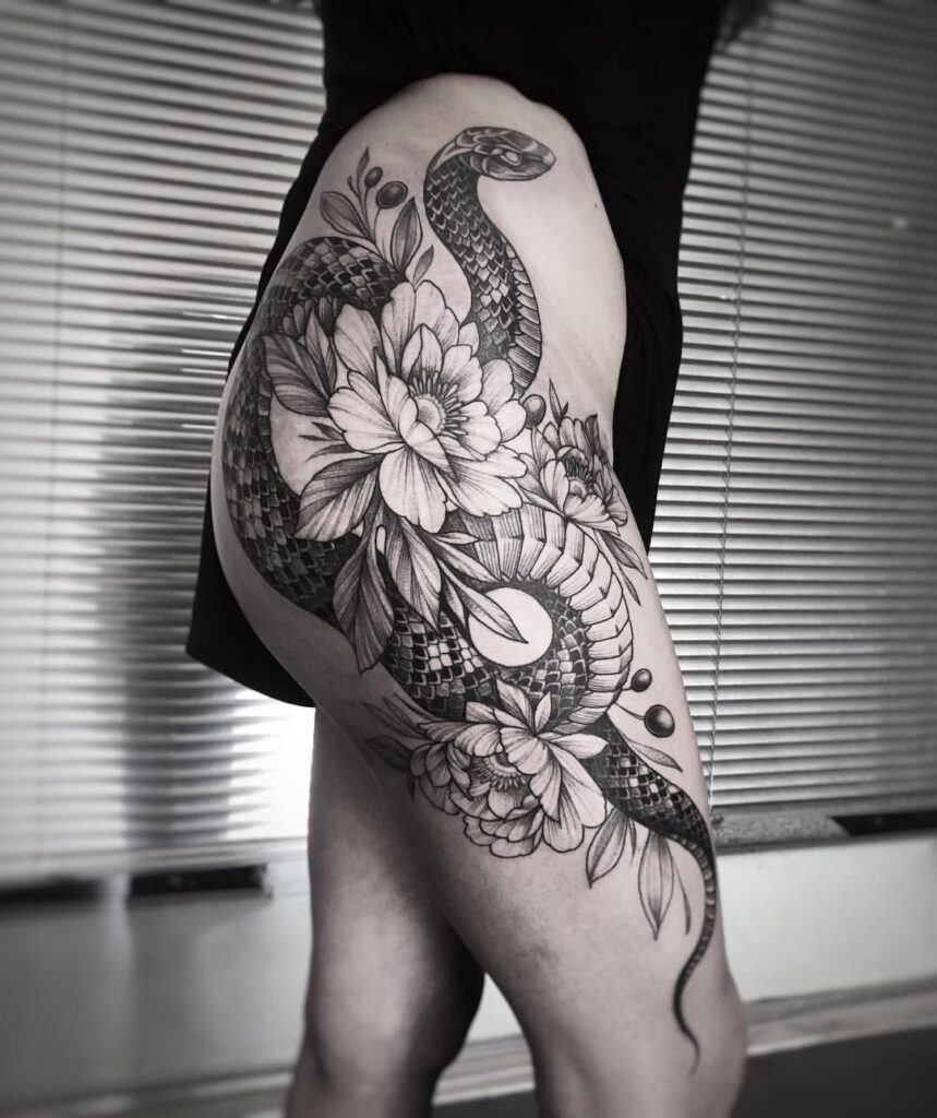 Large flower and snake tattoo on the thigh for women