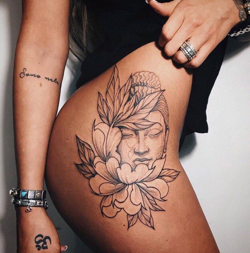 Buddha tattoo on the thigh for women