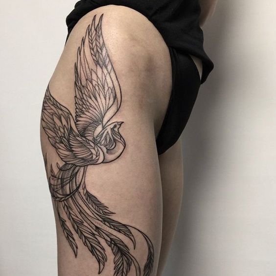 Tattoo of a phoenix on the thigh for women