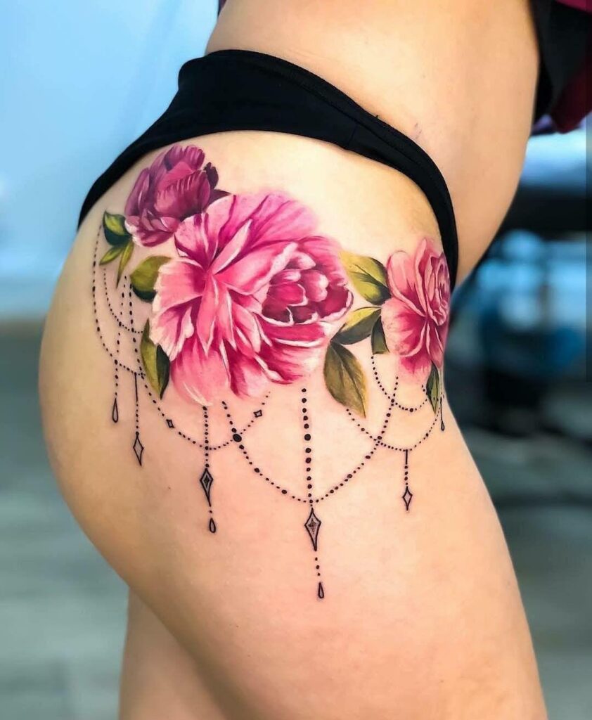 Colored peony tattoo on the hip for women