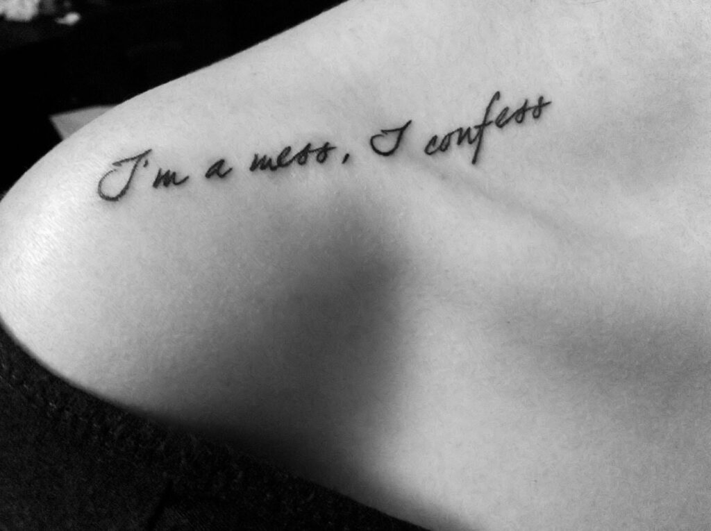 Tattoo with an inscription on the shoulder for women