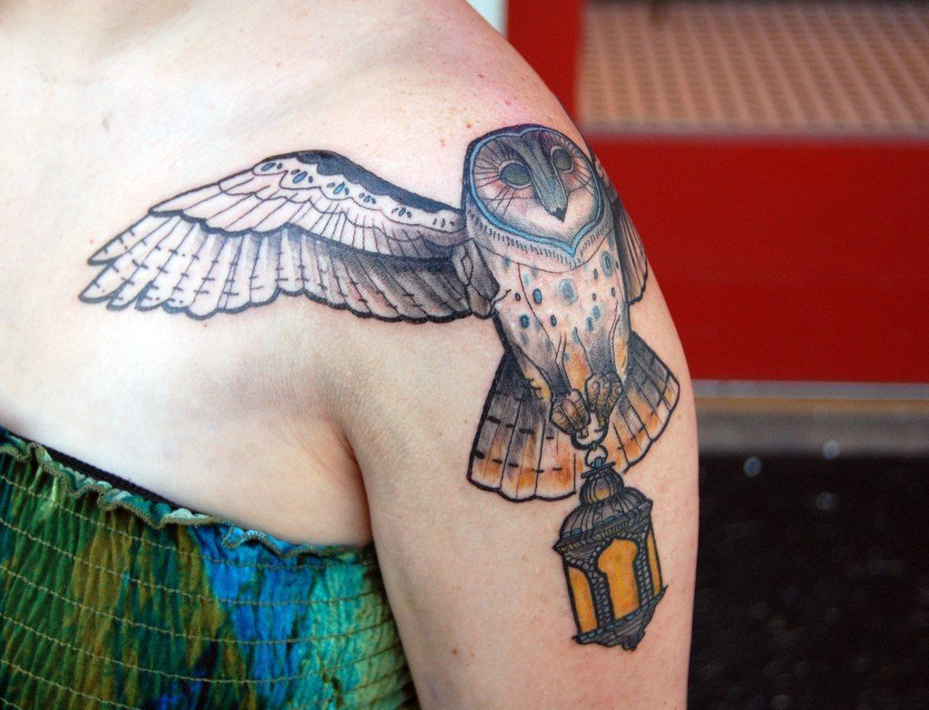 Colorful owl and lantern tattoo on the shoulder for women