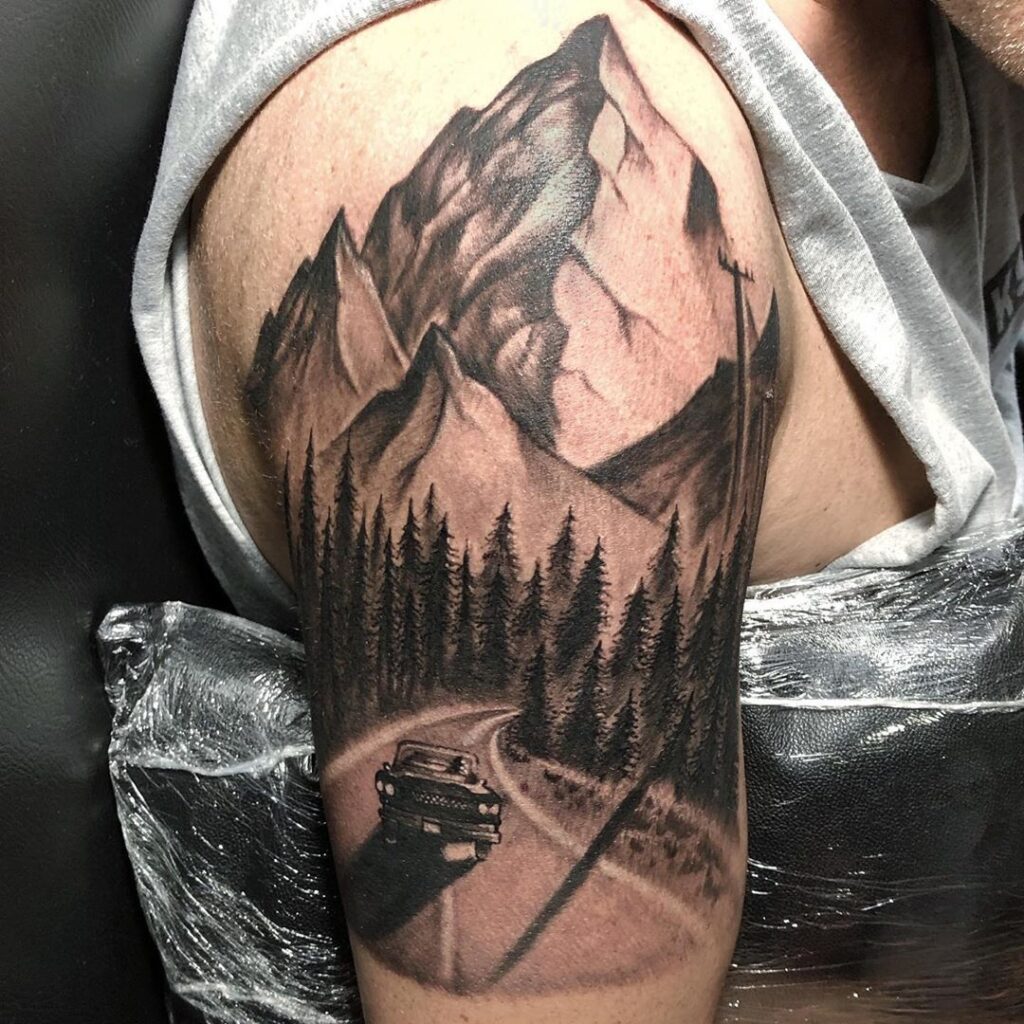 Large mountain tattoo on the shoulder for women