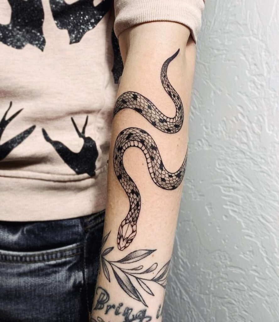 Snake tattoo on forearm for women