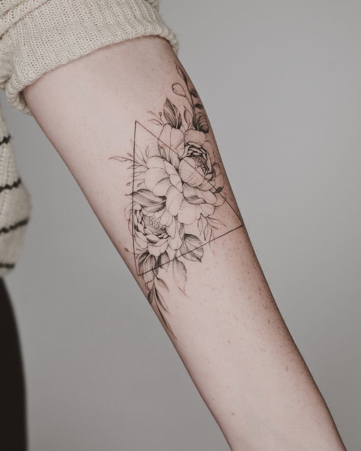 Peony tattoo in a triangle on the forearm for women