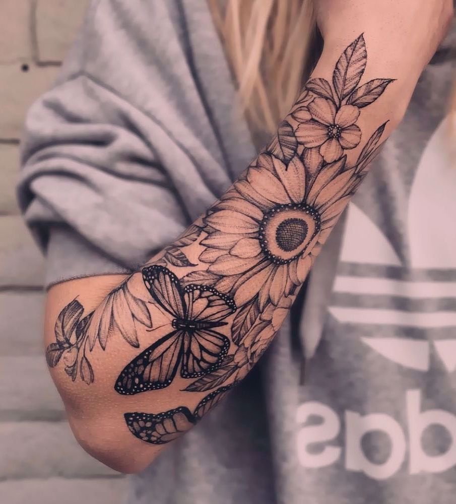 Sunflower and butterfly tattoo on the forearm for women