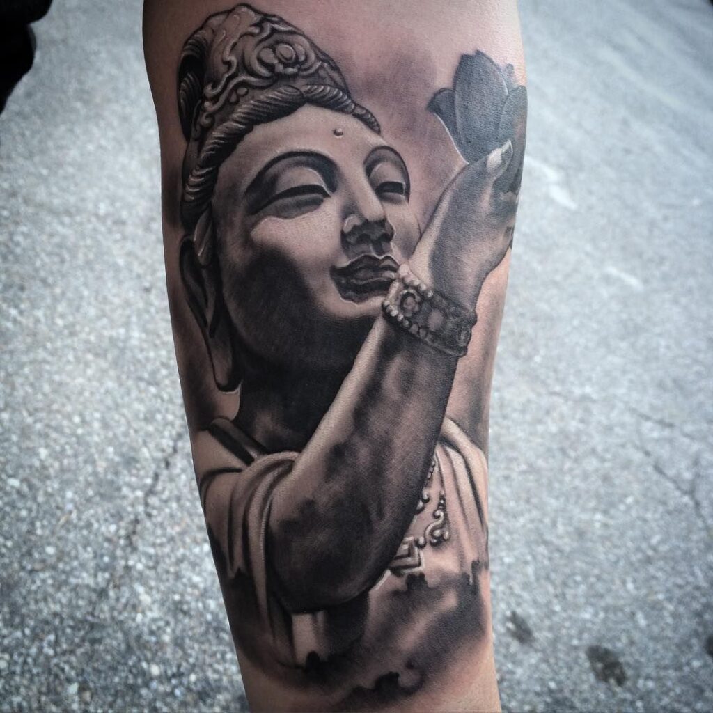 Tattoo of Buddha in black&grey style on the shin for men