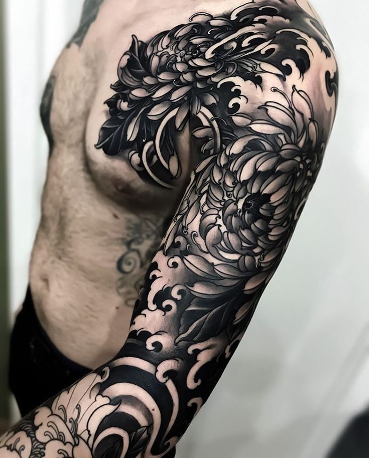 Large black&grey style flower tattoo on the arm for men