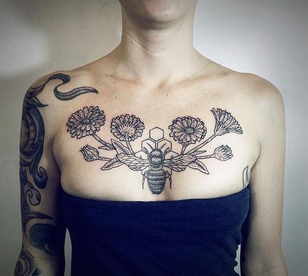 Bee tattoo on the chest for women