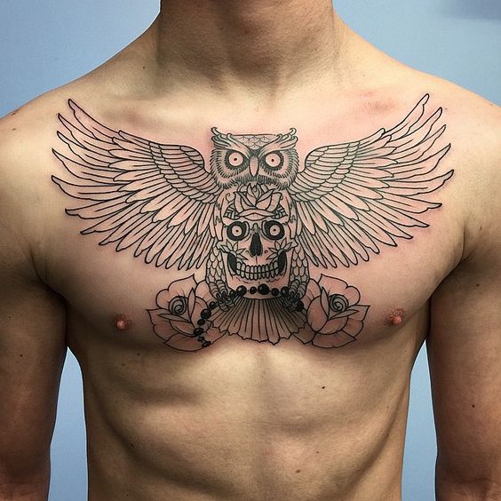 Tattoo of an owl with a skeleton on the chest for men