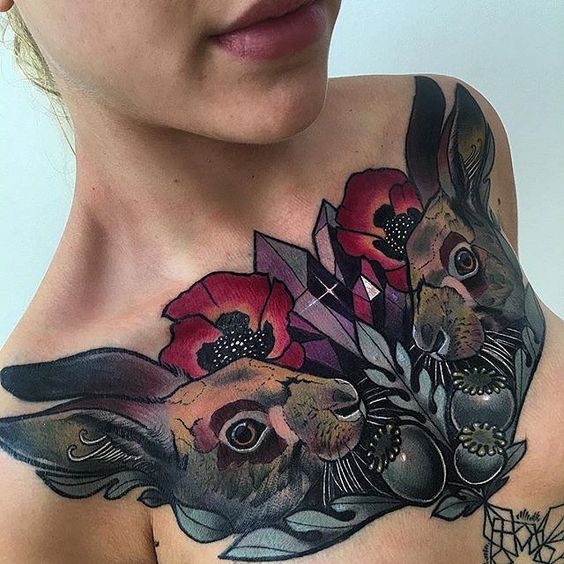 Colorful tattoo of two hares on the chest for women