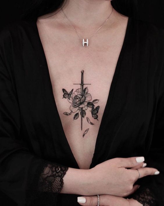 Peony and dagger tattoo on the chest for women