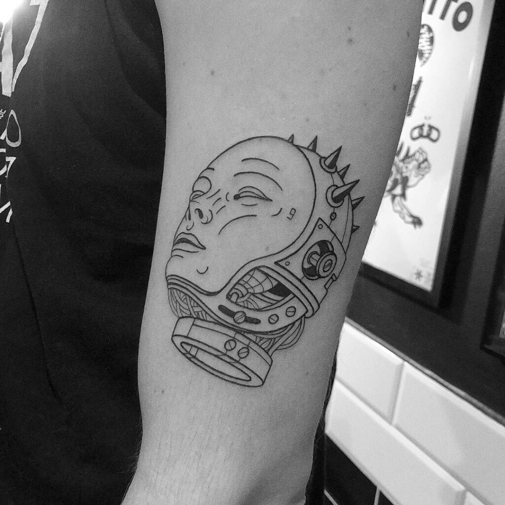 Tattoo of a robot head in graphic style on the shoulder for men