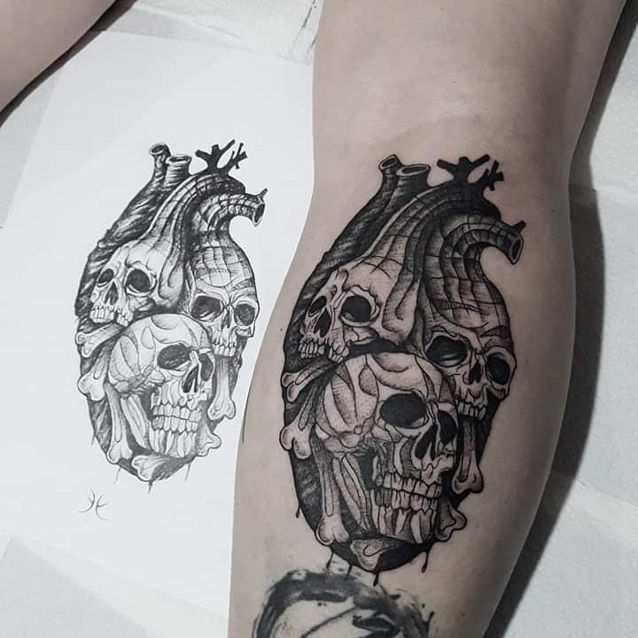 Tattoo of skulls and hearts in graphic style on calves for women