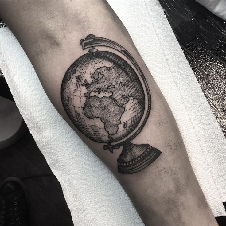 Graphic style globe tattoo on forearm for men