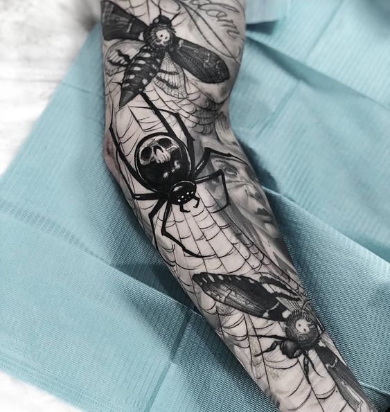 Graphic style spider tattoo on forearm for men