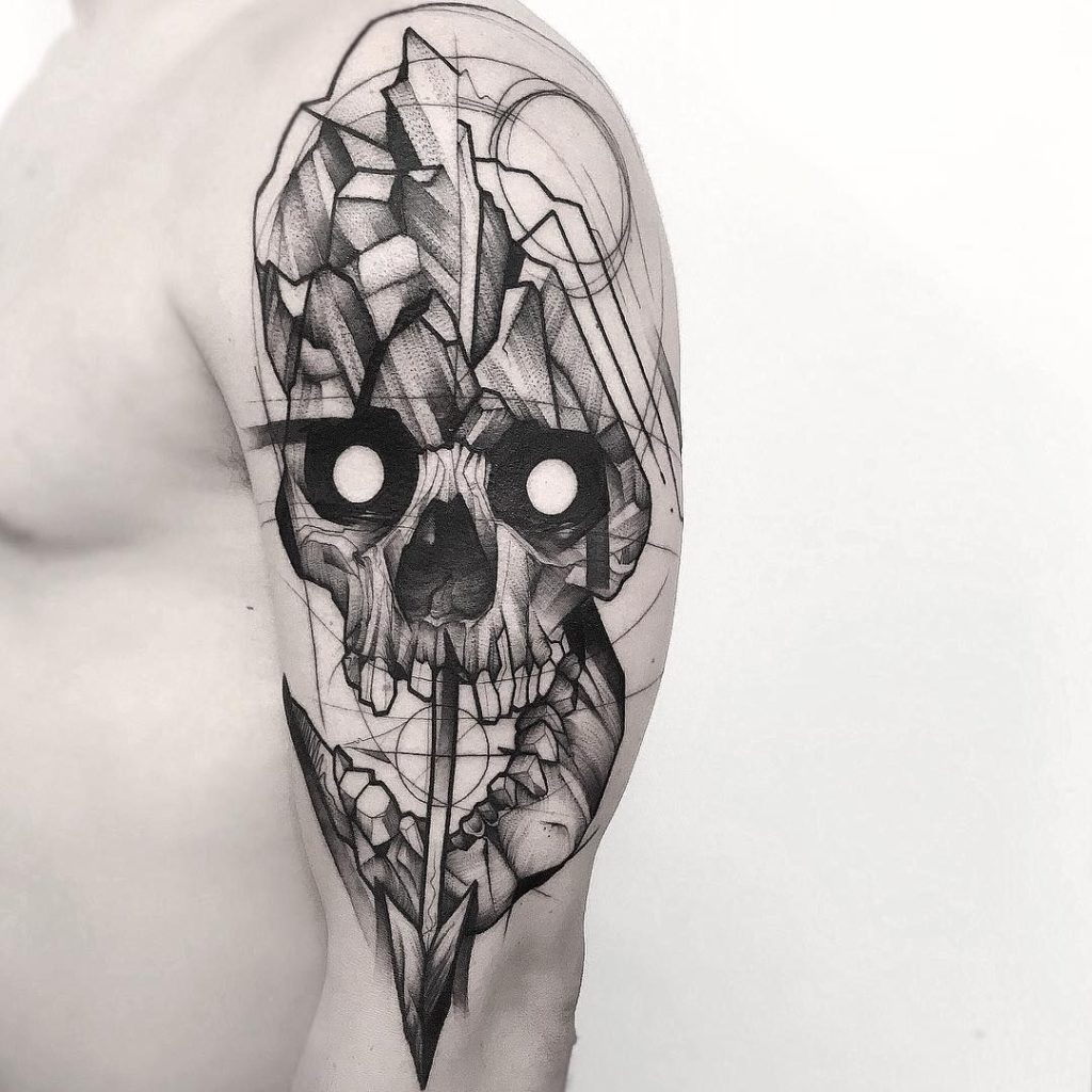 Large graphic skull tattoo on the shoulder for men