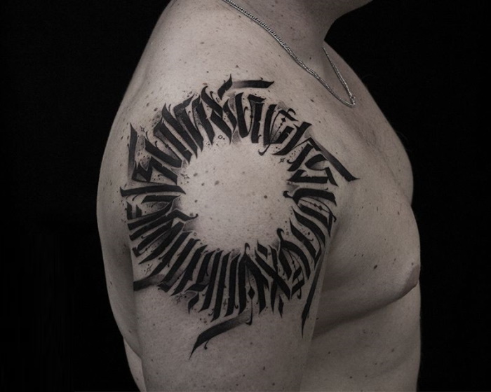 Calligraphy tattoo on the shoulder for men