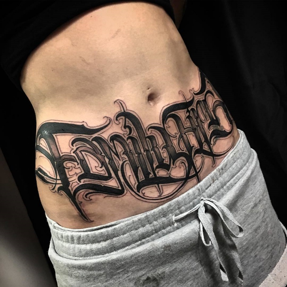 Calligraphy style tattoo on the stomach for women